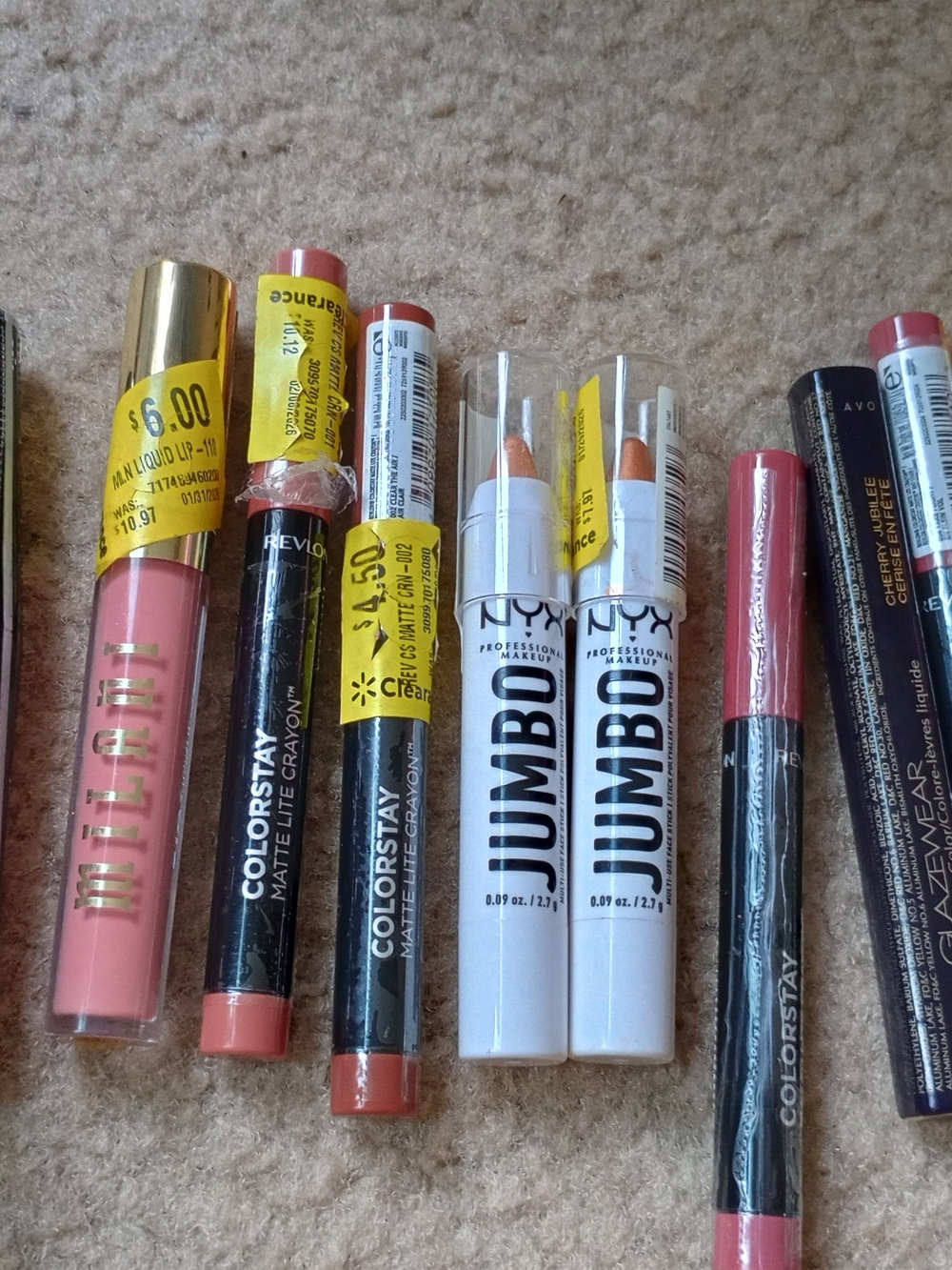 various cosmetic products from brands like Milani, Revlon, NYX, and Wet n Wild.